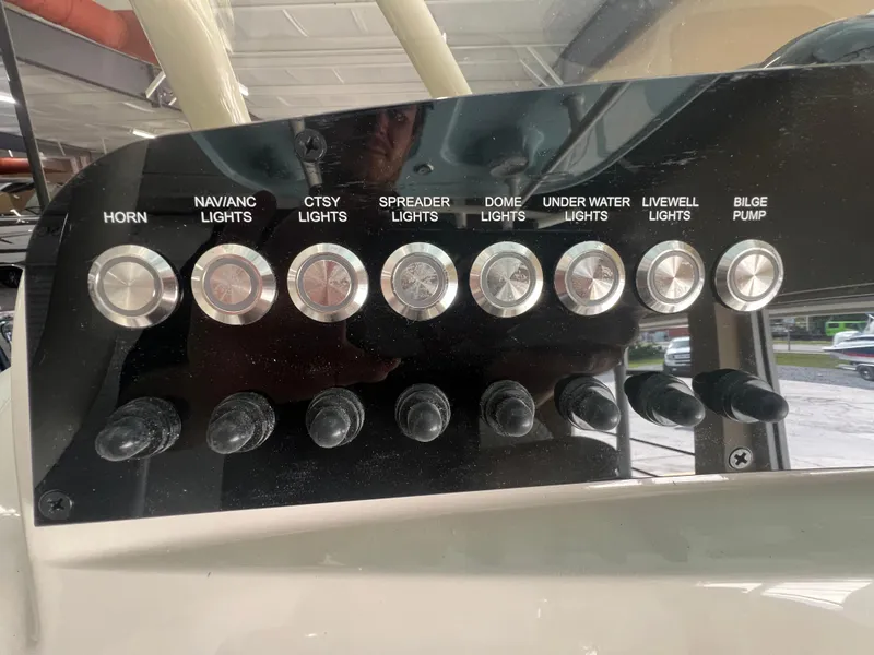 Slide: The Image of Control panel of 2026 Pioneer 220 Bay Sport boat with labeled switches for various functions. - 12