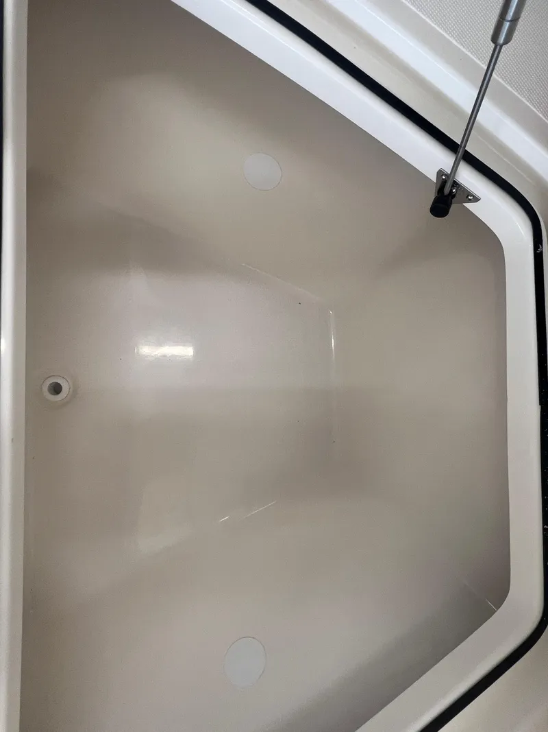 Slide: The Image of Storage compartment of 2026 Pioneer 220 Bay Sport boat, featuring a clean, spacious interior. - 23