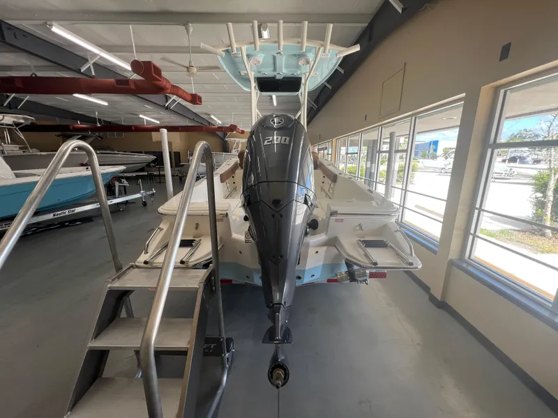 Slide: The Image of 2026 Pioneer 220 Bay Sport boat with powerful outboard motor in showroom. - 3