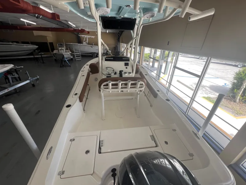Slide: The Image of 2026 Pioneer 220 Bay Sport boat interior in showroom, featuring seating and control console. - 4