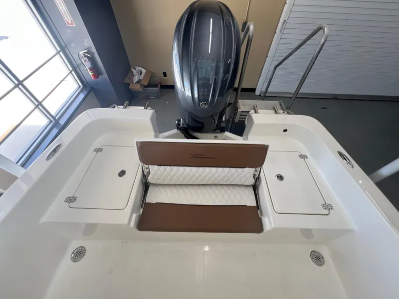 Slide: The Image of 2026 Pioneer 220 Bay Sport boat interior with seating and outboard motor. - 5
