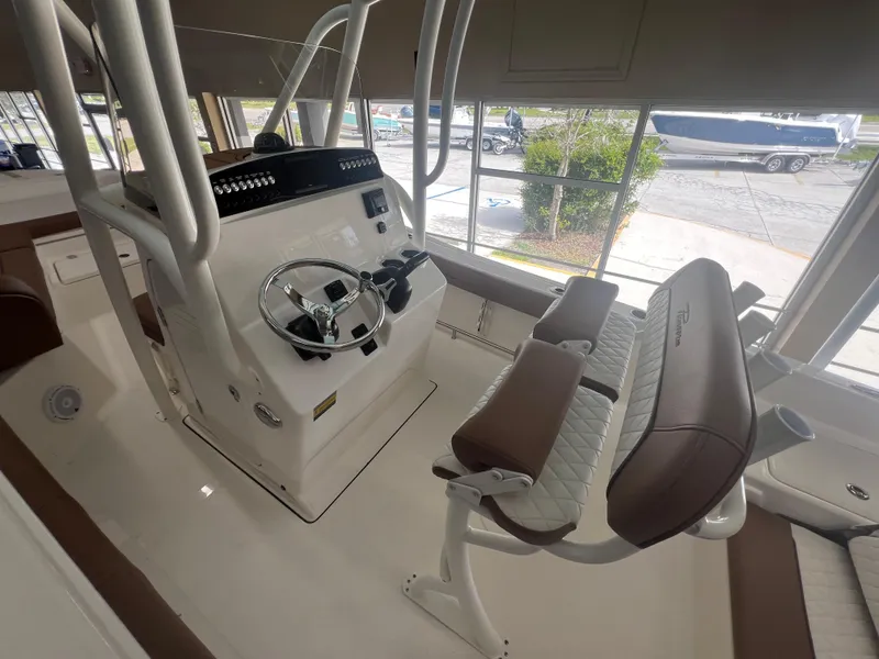 Slide: The Image of 2026 Pioneer 220 Bay Sport boat interior with steering console and seating. - 7