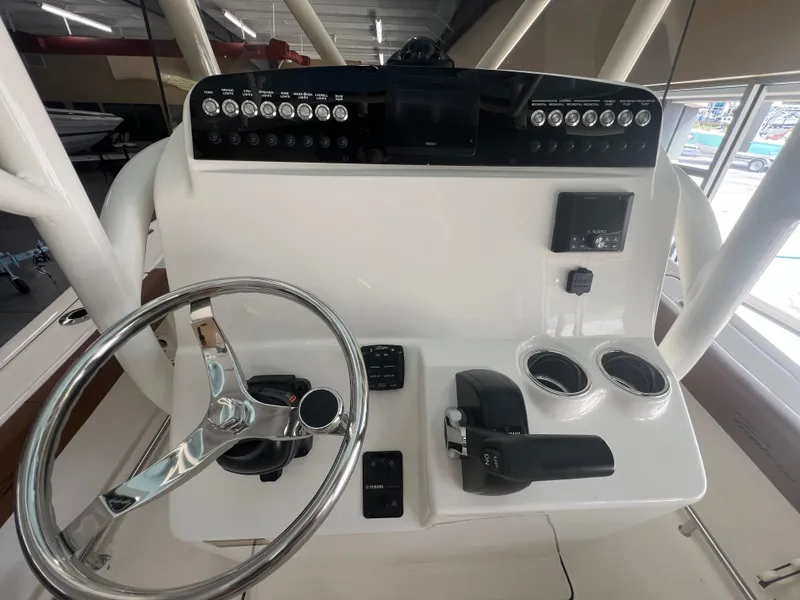Slide: The Image of 2026 Pioneer 220 Bay Sport boat console with steering wheel and controls. - 8