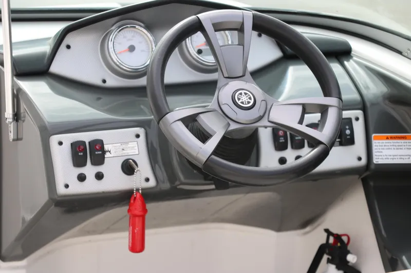 Slide: The Image of 2014 Yamaha Boats SX190 dashboard with steering wheel and control panel. - 11