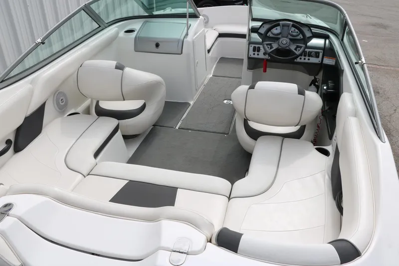 Slide: The Image of 2014 Yamaha Boats SX190 interior with white seating and modern dashboard design. - 12