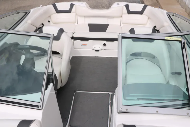 Slide: The Image of 2014 Yamaha Boats SX190 interior with white seating and dual windshields. - 14