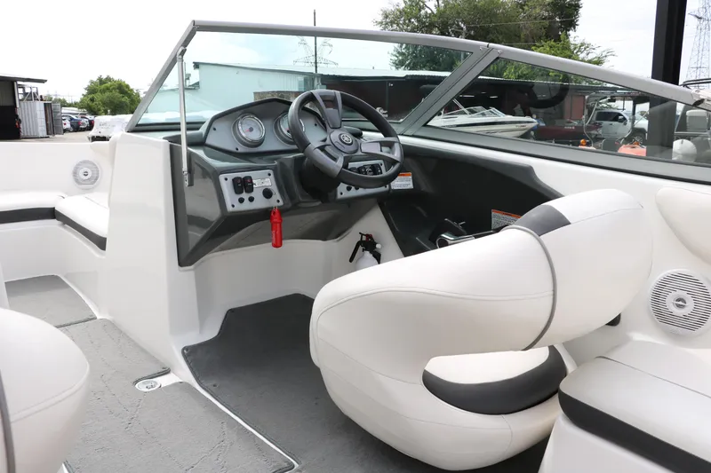 Slide: The Image of 2014 Yamaha Boats SX190 interior with steering wheel and dashboard, featuring white seating. - 16