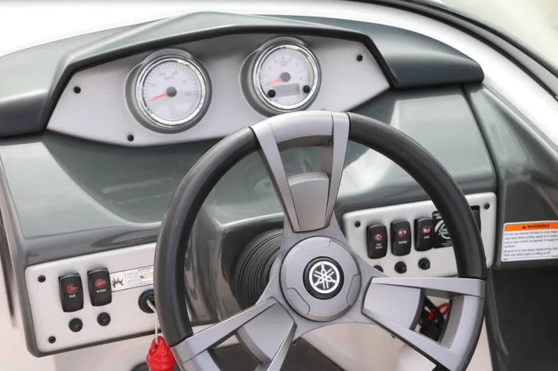 Slide: The Image of 2014 Yamaha Boats SX190 dashboard with steering wheel and gauges. - 21