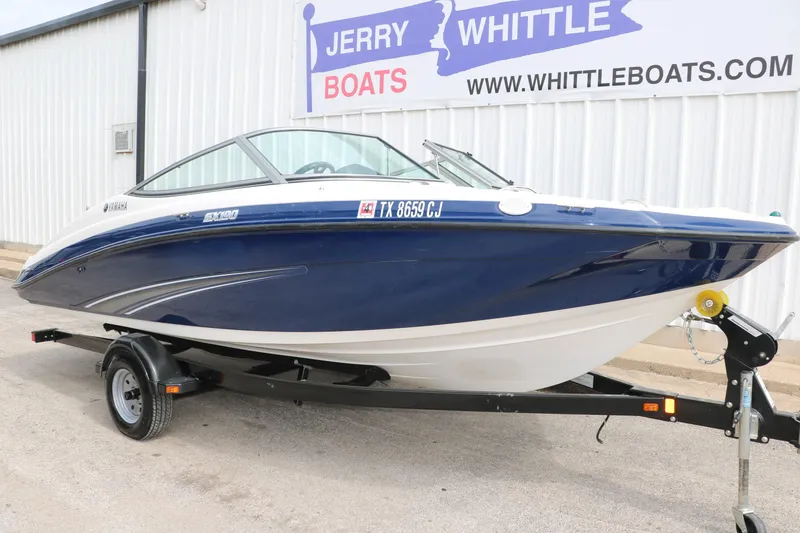 Slide: The Image of 2014 Yamaha SX190 boat on trailer at dealership, Jerry Whittle Boats. - 4
