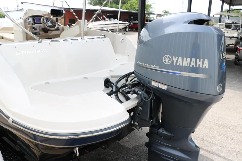 Slide: The Image of 2015 Stingray 192 SC boat with Yamaha 150 outboard motor, docked outdoors. - 10