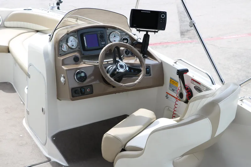 Slide: The Image of 2015 Stingray 192 SC boat cockpit with steering wheel, gauges, and navigation system. - 16