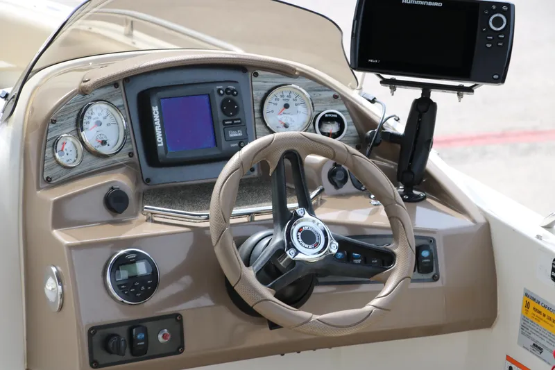 Slide: The Image of 2015 Stingray 192 SC boat dashboard with steering wheel and navigation instruments. - 17
