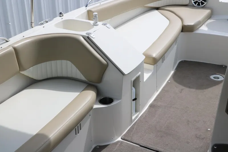 Slide: The Image of 2015 Stingray 192 SC boat interior with beige seating and carpeted floor. - 20