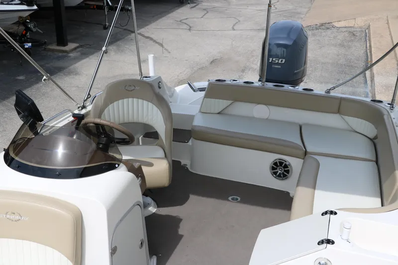 Slide: The Image of 2015 Stingray 192 SC boat interior with seating and steering console. - 25