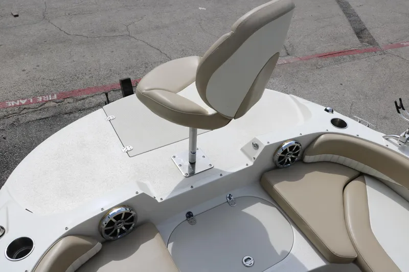 Slide: The Image of 2015 Stingray 192 SC boat interior with beige seating and speaker system. - 26