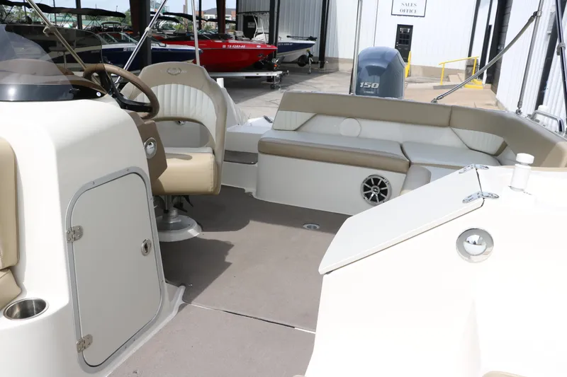 Slide: The Image of 2015 Stingray 192 SC boat interior with beige seating and steering wheel. - 27