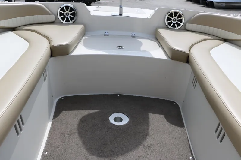 Slide: The Image of Interior of a 2015 Stingray 192 SC boat with beige seating and speakers. - 29