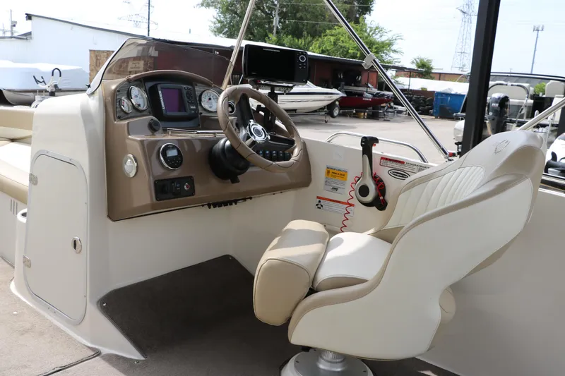 Slide: The Image of 2015 Stingray 192 SC boat cockpit with steering wheel and control panel. - 33