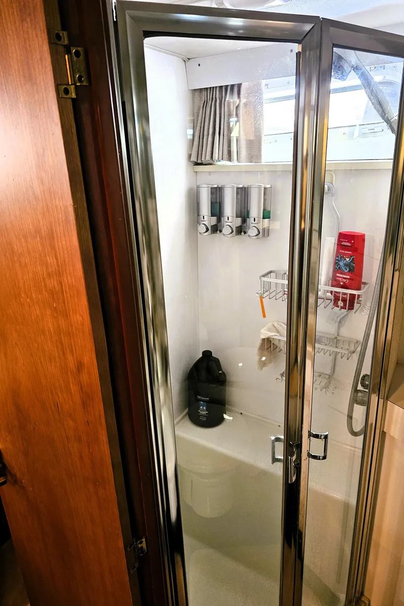 Slide: The Image of Shower area in a 1995 Silverton 46 yacht with glass door and toiletries. - 27