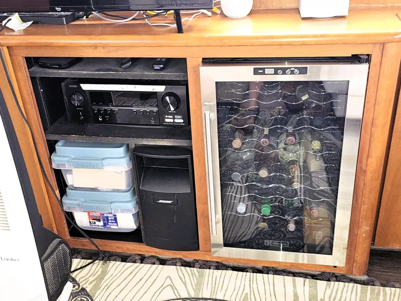 Slide: The Image of Wooden cabinet with audio equipment and a wine cooler, Silverton 46, 1995 model. - 31