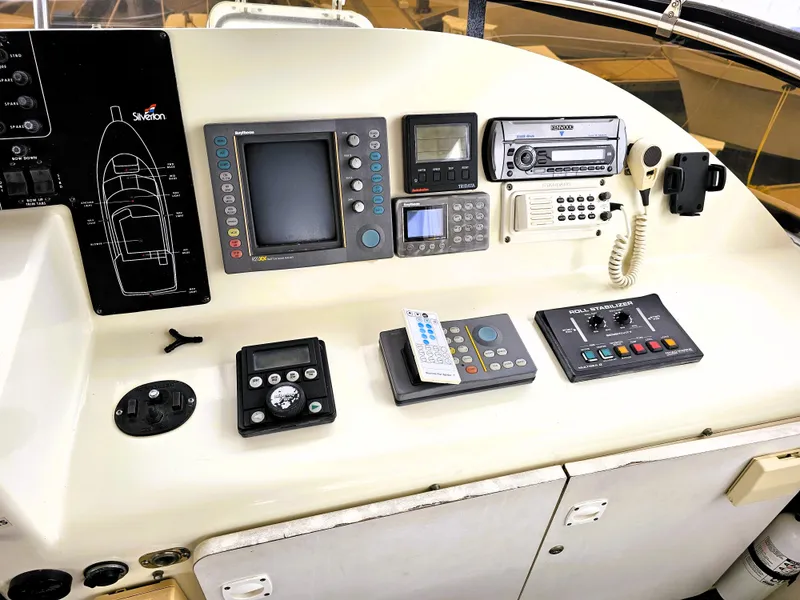 Slide: The Image of Control panel of a 1995 Silverton 46 yacht with navigation and communication equipment. - 5