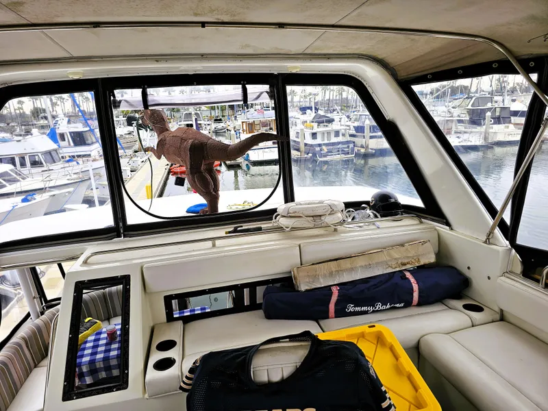 Slide: The Image of Interior of a 1995 Silverton 46 yacht with a dinosaur sculpture outside. - 6