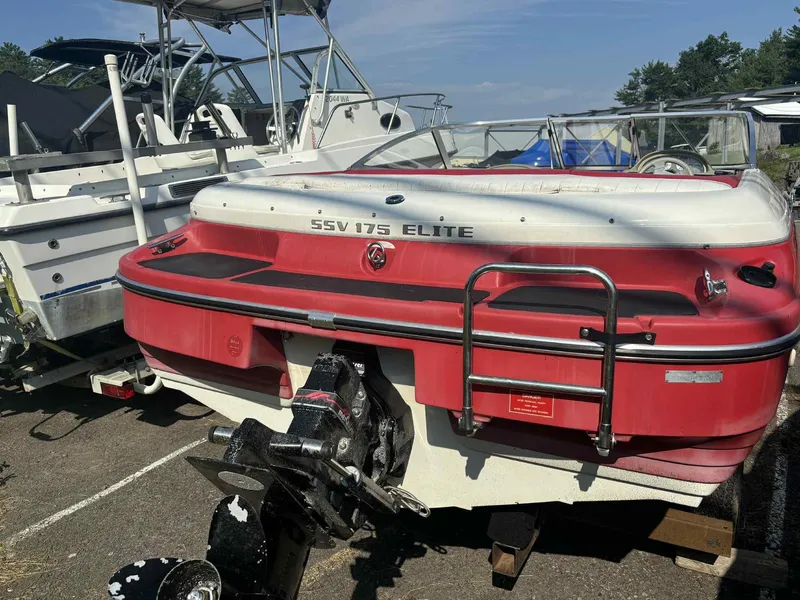 Slide: The Image of 1993 Glastron SSV 175 Elite boat, red and white, parked on a trailer. - 10