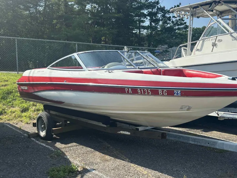 Slide: The Image of 1993 Glastron SSV 175 boat on trailer, red and white, parked outdoors. - 12