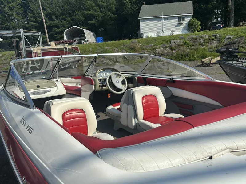 Slide: The Image of 1993 Glastron SSV 175 boat with red and white interior, parked outdoors. - 16