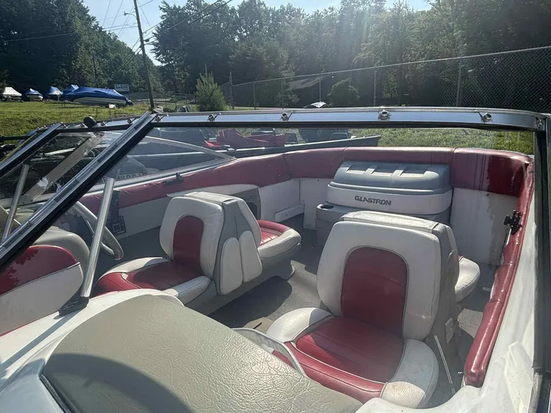 Slide: The Image of 1993 Glastron SSV 175 boat interior with red and white seating, outdoors. - 4