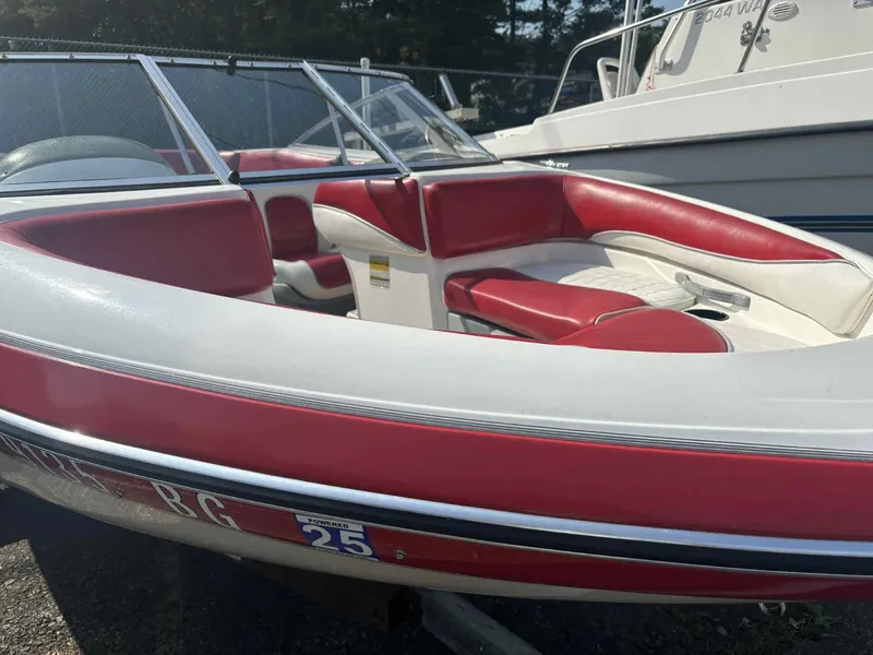 Slide: The Image of 1993 Glastron SSV 175 boat with red and white interior, docked outdoors. - 5