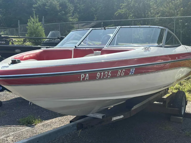Slide: The Image of 1993 Glastron SSV 175 boat with red and white design on a trailer. - 9