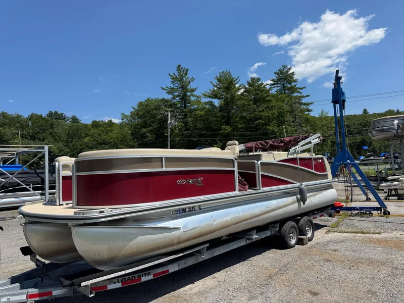 Slide: The Image of 2011 Harris Grand Mariner SEL 250 pontoon boat on trailer under clear blue sky. - 1