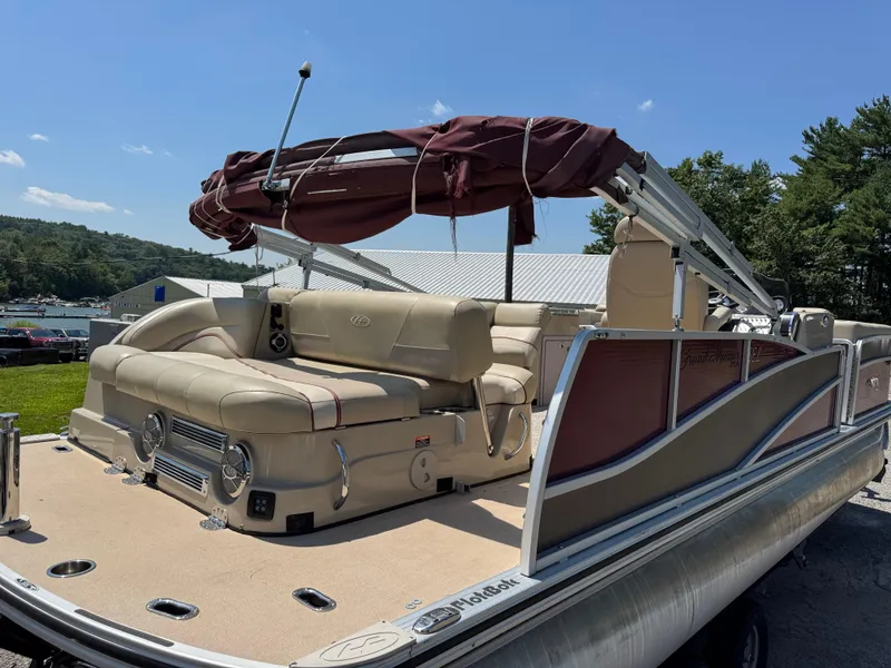 Slide: The Image of 2011 Harris Grand Mariner SEL 250 pontoon boat with beige seating and maroon canopy. - 3