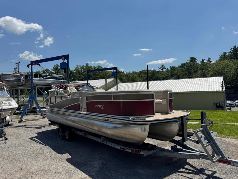 Slide: The Image of 2011 Harris Grand Mariner SEL 250 pontoon boat on trailer under clear blue sky. - 4