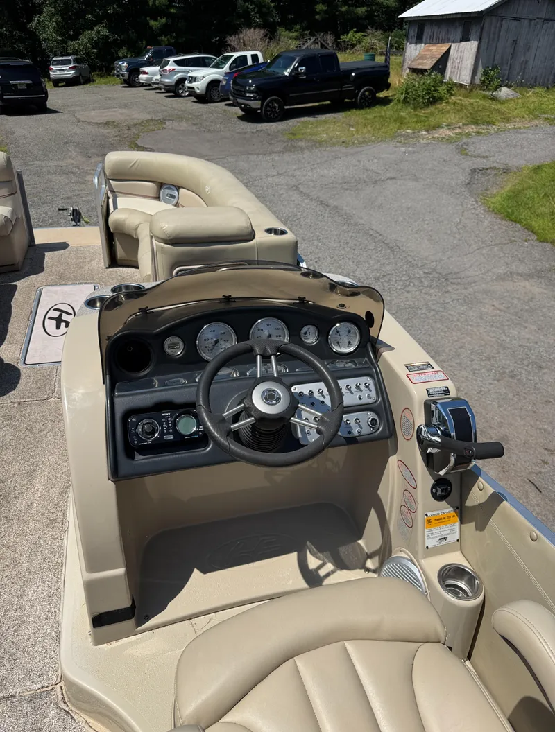 Slide: The Image of 2011 Harris Grand Mariner SEL 250 boat dashboard with steering wheel and gauges. - 7