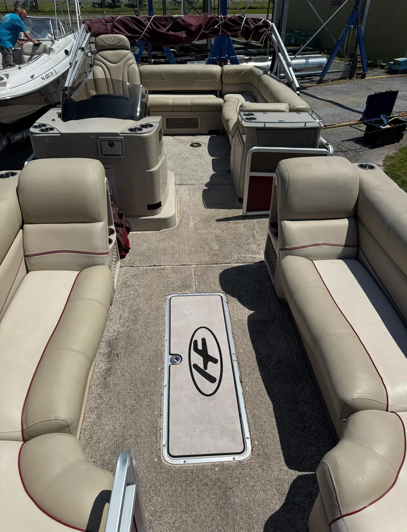 Slide: The Image of 2011 Harris Grand Mariner SEL 250 pontoon boat interior with beige seating and helm. - 8