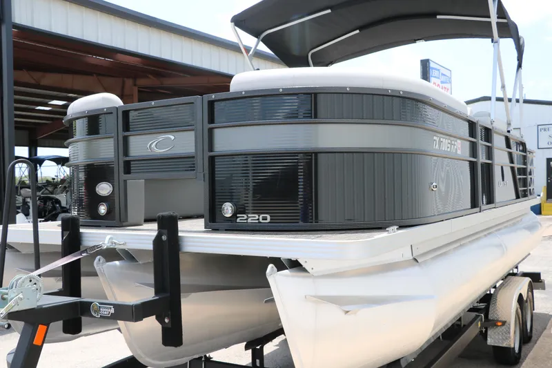 Slide: The Image of 2022 Crest Classic Fish 220 pontoon boat on trailer, parked outdoors. - 10