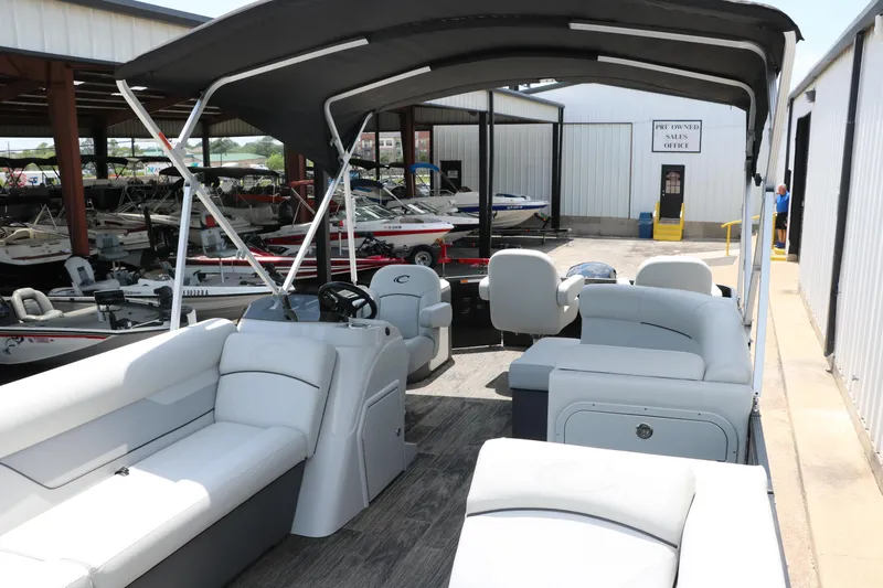 Slide: The Image of 2022 Crest Classic Fish 220 pontoon boat interior at a marina showroom. - 13
