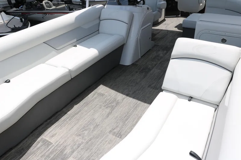 Slide: The Image of Interior of 2022 Crest Classic Fish 220 pontoon boat with white seating and wood-style flooring. - 14