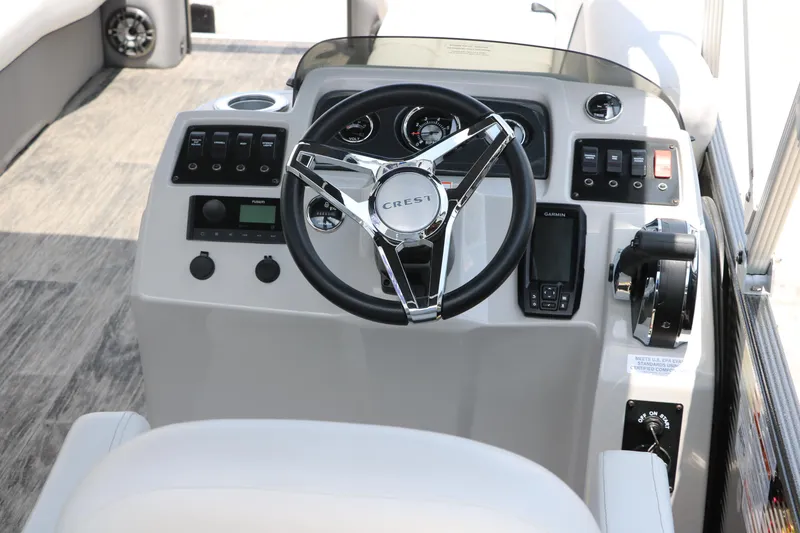 Slide: The Image of 2022 Crest Classic Fish 220 boat dashboard with steering wheel and controls. - 18