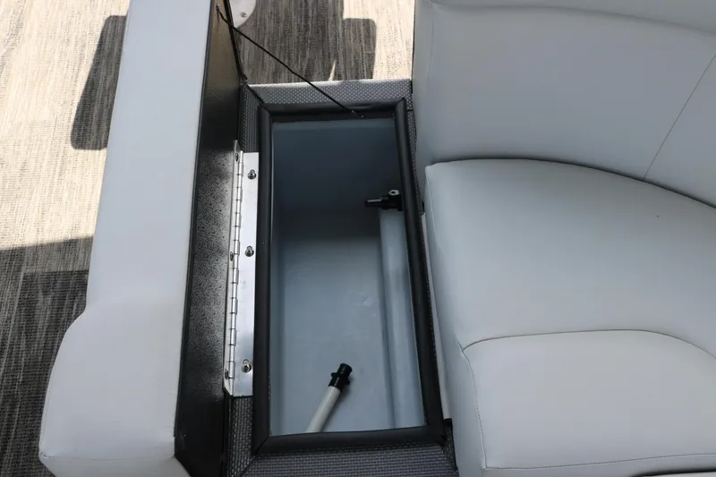 Slide: The Image of Storage compartment in 2022 Crest Classic Fish 220 boat with white cushioned seating. - 20