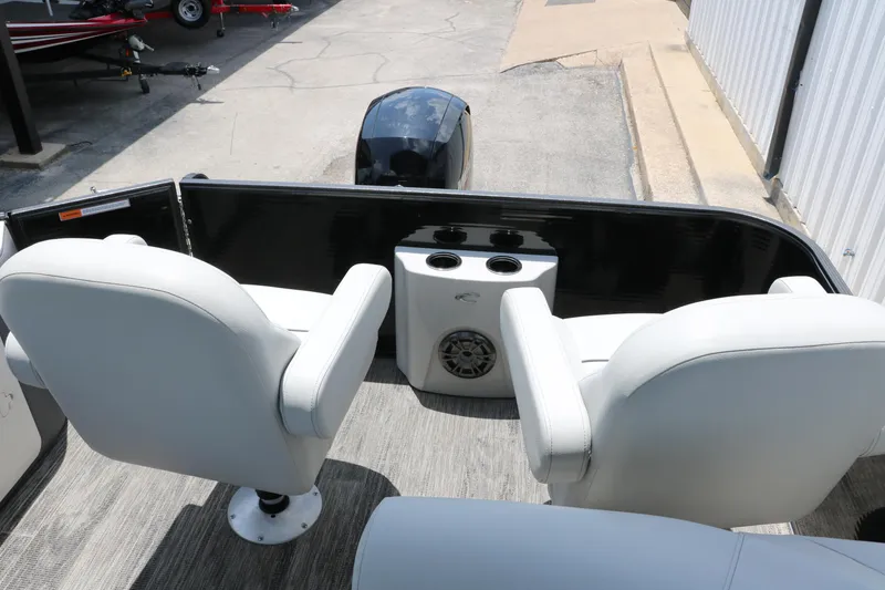 Slide: The Image of 2022 Crest Classic Fish 220 boat interior with white seats and cup holders. - 21