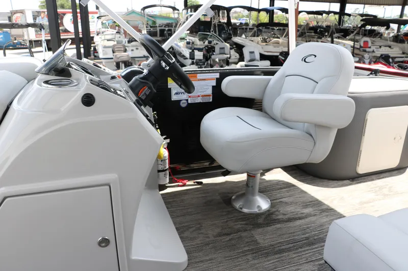 Slide: The Image of 2022 Crest Classic Fish 220 boat interior with steering wheel and captain's chair. - 22