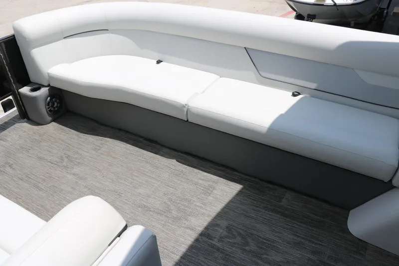 Slide: The Image of 2022 Crest Classic Fish 220 boat interior with white seating and gray flooring. - 24