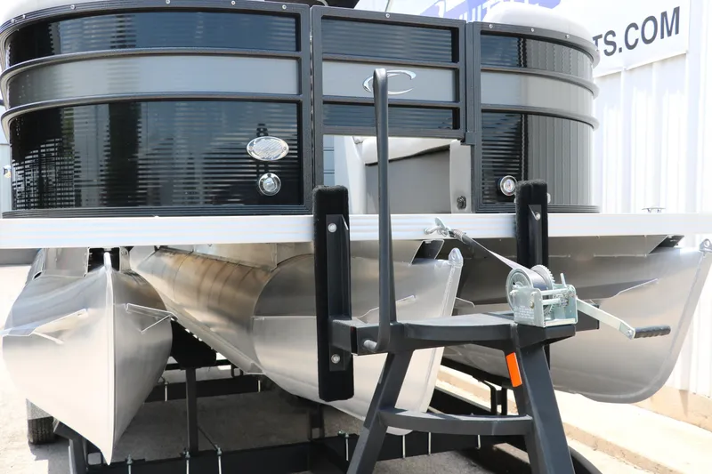 Slide: The Image of 2022 Crest Classic Fish 220 pontoon boat on trailer, close-up view. - 32