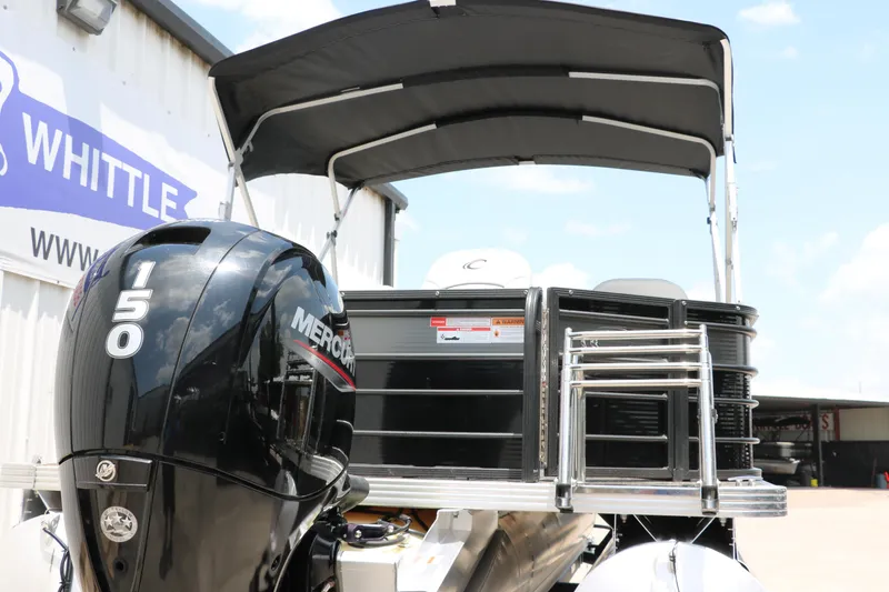 Slide: The Image of 2022 Crest Classic Fish 220 boat with Mercury 150 engine, displayed outdoors. - 4