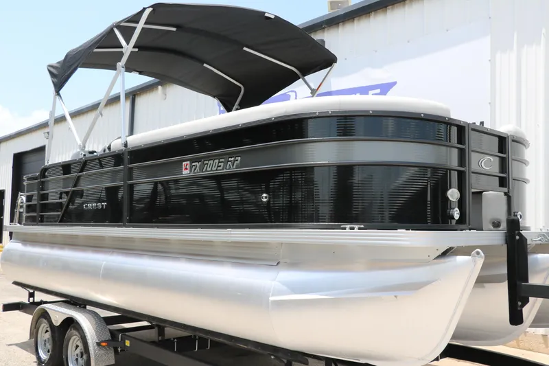 Slide: The Image of 2022 Crest Classic Fish 220 pontoon boat with black canopy on trailer. - 6