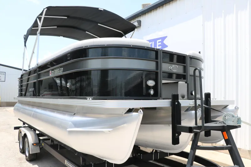 Slide: The Image of 2022 Crest Classic Fish 220 pontoon boat on trailer, black and silver design. - 7