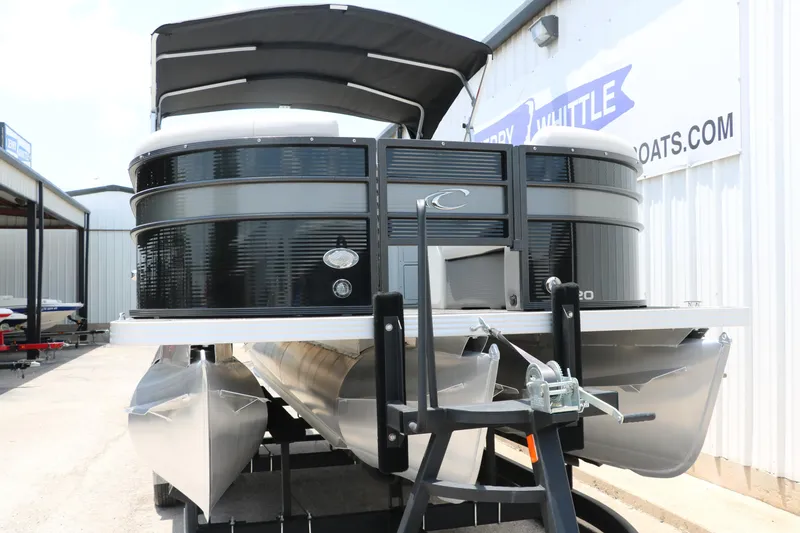 Slide: The Image of 2022 Crest Classic Fish 220 pontoon boat with black exterior, docked at a marina. - 8